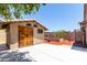 Exterior view of the shed with rustic wooden door at 21284 E Camacho Rd, Queen Creek, AZ 85142