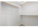Bright walk-in closet with shelving, rod system, and carpeted floor at 21284 E Camacho Rd, Queen Creek, AZ 85142