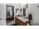 Well-lit bathroom featuring a sink vanity, three-panel mirror, and door to main bedroom at 2233 E Behrend Dr # 162, Phoenix, AZ 85024
