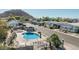Kidney shaped community pool with lush landscaping and lounge seating at 2233 E Behrend Dr # 162, Phoenix, AZ 85024