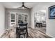 Dining area featuring wood floors, neutral walls, three pane window, and ceiling fan at 2233 E Behrend Dr # 162, Phoenix, AZ 85024