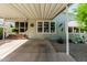 Exterior view with covered carport and small, desert-friendly yard with mature plants at 2233 E Behrend Dr # 162, Phoenix, AZ 85024