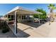Exterior view of home featuring a covered carport, desert landscaping, and palm tree at 2233 E Behrend Dr # 162, Phoenix, AZ 85024