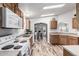 Open kitchen featuring wood cabinets, wood look flooring, and plenty of natural light at 2233 E Behrend Dr # 162, Phoenix, AZ 85024