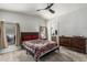 Comfortable main bedroom featuring an ensuite bathroom, wood furnishings, and modern ceiling fan at 2233 E Behrend Dr # 162, Phoenix, AZ 85024