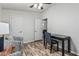 Bright office space with modern desk, chair, wood look flooring, and ceiling fan at 2233 E Behrend Dr # 162, Phoenix, AZ 85024