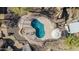 Aerial view of pool featuring a unique shape, patio furniture, and desert landscaping at 2233 E Behrend Dr # 162, Phoenix, AZ 85024