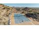 This is a top down view of a fenced tennis court, showcasing community recreational amenity surrounded by desert landscape at 2233 E Behrend Dr # 162, Phoenix, AZ 85024