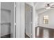 Cozy bedroom with neutral walls, ceiling fan, and wood-look flooring and an ensuite with walk-in closet at 2250 E Deer Valley Rd # 26, Phoenix, AZ 85024