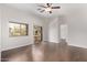 Bright bedroom with hardwood flooring, ceiling fan, and sliding glass door to a balcony at 2250 E Deer Valley Rd # 26, Phoenix, AZ 85024