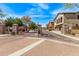 View of a gated community entrance with well-maintained landscaping and paved roads under a sunny sky at 2250 E Deer Valley Rd # 26, Phoenix, AZ 85024