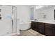 A sleek bathroom featuring a soaking tub, walk-in shower, and vanity with double sinks at 22938 E Calle Luna --, Queen Creek, AZ 85142