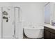 A sleek bathroom featuring a soaking tub and walk-in shower at 22938 E Calle Luna --, Queen Creek, AZ 85142