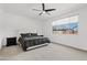 Bright bedroom featuring a ceiling fan and a large window with neighborhood views at 22938 E Calle Luna --, Queen Creek, AZ 85142