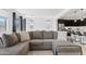 Spacious living room with a large sectional sofa, hardwood floors, plenty of natural light, and open-concept design at 22938 E Calle Luna --, Queen Creek, AZ 85142