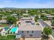 Aerial shot showing a pool, backyard, and roof solar panels in a residential neighborhood at 2466 E Harrison Ct, Gilbert, AZ 85295