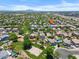Expansive aerial view of a vibrant community with lush green spaces, pools, and mountain views on a sunny day at 2466 E Harrison Ct, Gilbert, AZ 85295