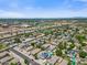 Bright aerial shot showcases a neighborhood with swimming pools, solar panels, and distant mountain views at 2466 E Harrison Ct, Gilbert, AZ 85295
