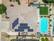 Aerial view of the home highlighting the solar panels, backyard pool, manicured lawn, and desert landscaping at 2466 E Harrison Ct, Gilbert, AZ 85295