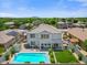 Backyard aerial view of pool, lawn, covered patio, and exterior, featuring mountain views at 2466 E Harrison Ct, Gilbert, AZ 85295