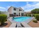 Inviting backyard oasis featuring a sparkling pool, lounge chairs, patio with seating, and lush landscaping at 2466 E Harrison Ct, Gilbert, AZ 85295
