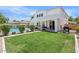 Spacious backyard with lush lawn, pool, patio with BBQ, and partial fence at 2466 E Harrison Ct, Gilbert, AZ 85295