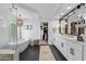 Bright bathroom with white vanities and a freestanding tub in front of a window at 2466 E Harrison Ct, Gilbert, AZ 85295