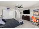 Cozy bedroom features a ceiling fan, closet with white doors, and a dresser at 2466 E Harrison Ct, Gilbert, AZ 85295