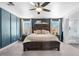 Primary bedroom with blue walls, a wood-framed bed and an adjacent ensuite bathroom at 2466 E Harrison Ct, Gilbert, AZ 85295