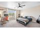 Comfortable bedroom featuring a ceiling fan, carpeted floor and a large window at 2466 E Harrison Ct, Gilbert, AZ 85295