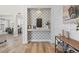 Inviting entryway with decorative wallpaper, a stylish mirror, and a wood-look console table, setting a warm and elegant tone at 2466 E Harrison Ct, Gilbert, AZ 85295