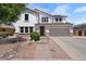 Charming two-story home featuring a well-manicured lawn, complemented by an attached two-car garage and traditional design elements at 2466 E Harrison Ct, Gilbert, AZ 85295