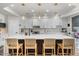 Bright, eat-in kitchen featuring a large island with a white countertop and modern pendant lighting at 2466 E Harrison Ct, Gilbert, AZ 85295