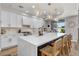Modern kitchen with white cabinets, a large center island, and pendant lighting, combining style and functionality for cooking at 2466 E Harrison Ct, Gilbert, AZ 85295