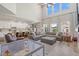 Open concept living room with large sofa, kitchen island, and lots of natural light at 2466 E Harrison Ct, Gilbert, AZ 85295