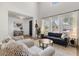 Bright living room featuring wainscotting, large windows, hardwood floors and comfortable seating, creating a welcoming atmosphere at 2466 E Harrison Ct, Gilbert, AZ 85295