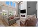 Bright living room showcasing high ceilings, a fireplace, large windows, and comfortable sectional sofa at 2466 E Harrison Ct, Gilbert, AZ 85295