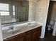 Bathroom with double vanity, a large mirror and a separate toilet at 24919 W Illini St, Buckeye, AZ 85326