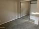 Neutral bedroom features a sliding door closet and carpeted floor at 24919 W Illini St, Buckeye, AZ 85326