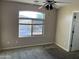 Bedroom featuring a ceiling fan, a window, and neutral paint at 24919 W Illini St, Buckeye, AZ 85326