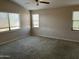 Spacious bedroom boasts three windows for natural light and a ceiling fan at 24919 W Illini St, Buckeye, AZ 85326
