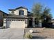 Charming two-story home with a two-car garage and desert landscaping at 24919 W Illini St, Buckeye, AZ 85326