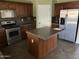 Traditional kitchen with stainless steel appliances, granite countertops, and a center island at 24919 W Illini St, Buckeye, AZ 85326