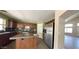Kitchen with stainless steel fridge, dark cabinets, and eat-in island at 24919 W Illini St, Buckeye, AZ 85326