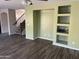 Living room with wood-look floors, a ceiling fan, and built-in shelving at 24919 W Illini St, Buckeye, AZ 85326