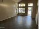 Open-concept living room with tile flooring and large windows for ample sunlight at 24919 W Illini St, Buckeye, AZ 85326