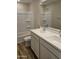 Bathroom with dual sinks, white cabinets, and a shower-tub combination at 3390 S 180Th Ln, Goodyear, AZ 85338