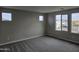 Bedroom featuring plush carpeting and bright natural light from the large windows at 3390 S 180Th Ln, Goodyear, AZ 85338