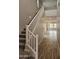 Bright, neutral colored entryway showing a carpeted staircase and wood look tile on the floor at 3390 S 180Th Ln, Goodyear, AZ 85338