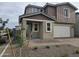 Two-story home with a two car garage and a charming covered entrance and neutral colored gravel landscaping at 3390 S 180Th Ln, Goodyear, AZ 85338